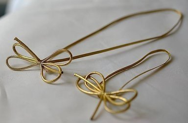 Rozet 4 noeud corde doré 23 cm